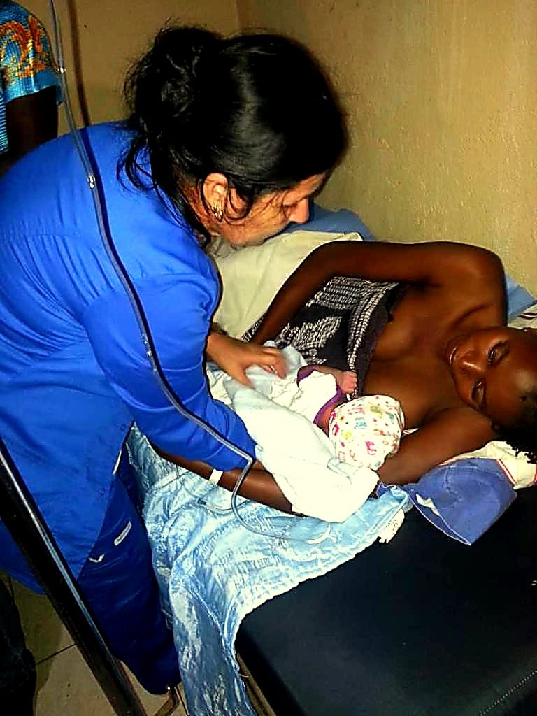 Nurse caring for mother and newborn